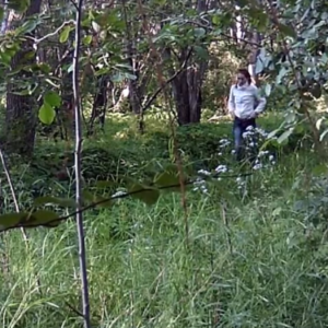 A young lady having trouble with her pants